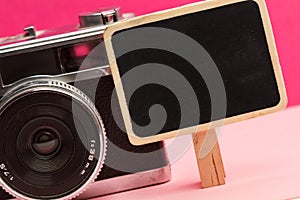 A photo camera with a little blackboard
