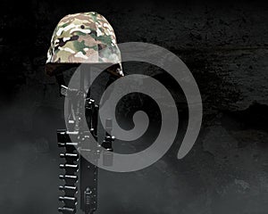 Fallen soldier camouflaged helmet on rifle
