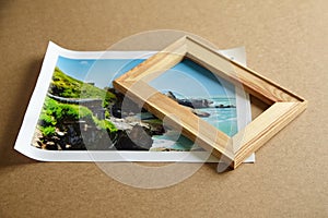 Photo canvas print and wooden stretcher bar on table. Landscape photography printed on canvas