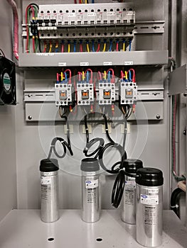 Photo of capacitor bank connection in electrical cabinet.