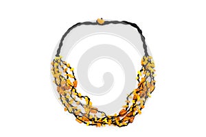 A photo captures a black-corded necklace adorned with polished Baltic amber. The golden-brown hues of the amber, set against the