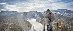 photo captures the serene beauty of the frozen Mana River in Siberia's Mana Loop, as a travel photographer takes in