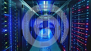A photo capturing the orderly arrangement of server rows in a data center, illuminated with blue and red lights, The inner