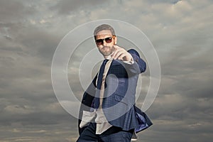 photo of carefree business man pointing finger in suit. carefree business man in suit