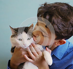 Photo of cat lover teenager boy hug cat close up funny photo