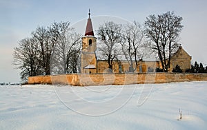 A photo of a catholic church in wintertime