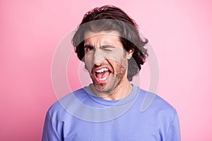 Photo of charming cheerful handsome man wink eye wear purple sweater isolated on pastel shine pastel pink color