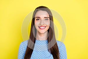 Photo of charming cheerful positive girl toothy beaming smile wear dotted blue dress isolated yellow color background