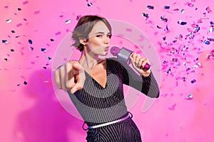 Photo of charming confident girl dressed glamour clothes signing karaoke showing finger you isolated pink color