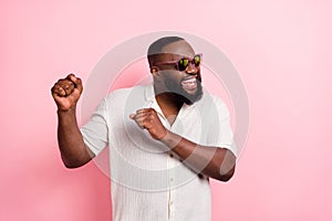 Photo of charming cool young man wear white shirt dark eyewear dancing isolated pink color background