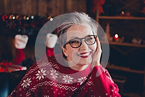 Photo of charming dreamy lady dressed red print x-mas pullover arm cheekbone celebrating new year indoors house room photo