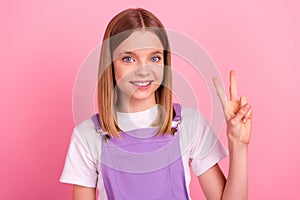 Photo of charming good mood girl showing v sign see best friend say hello hi  on pink color background