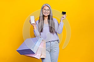 Photo of charming grey haired casual style grandma recommend you eshop online payment  on yellow color