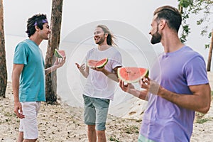 Photo of charming pretty young buddies dressed casual outfits talking eating tasty summer berry outdoors countryside