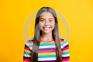 Photo of charming small girl toothy smile look camera wear striped shirt isolated yellow color background