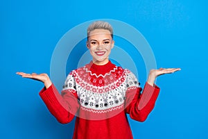 Photo of charming smiling young student lady wear red ornament christmas sweater balance palms choose best product