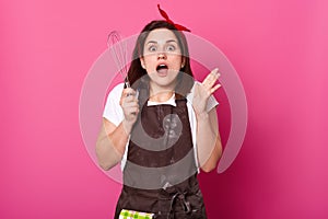 Photo of charming woman wants to make cake. Young female forget to buy importent ingredients for baking pie. Lady stands over rose