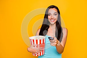 Photo of cheerful attractive charming cute nice tv watcher holding controller with her hands pop corn pot watching