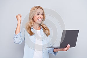 Photo of cheerful beautiful businesswoman raise fist in victory successful contract project isolated on grey color