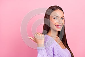 Photo of cheerful charming dreamy young woman point finger empty space thumb sale isolated on pink color background