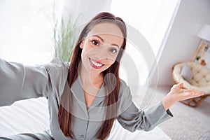 Photo of cheerful charming lady wear grey pajama enjoy weekend recording video vlog indoors house bedroom