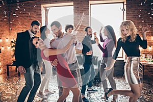 Photo of cheerful charming positive couple of two people dancing valse surrounded by their fellows in falling confetti
