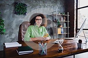 Photo of cheerful charming successful lady sitting in modern confort office day light workspace workstation photo