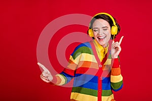 Photo of cheerful cool youngster lady good mood listen modern earphones popular song excited dj dancing lgbt party wear