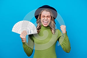 Photo of cheerful crazy curly lady hold fan dollar bucks rich person freelance salary successful business woman raise