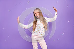 Photo of cheerful crazy funky little lady have fun soap bubble fly wear dotted pajama isolated purple color background