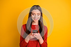 Photo of cheerful cute gorgeous attractive youngster holding telephone with hands smiling toothily browsing through