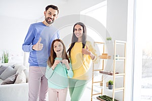 Photo of cheerful family happy positive smile show thumb-up like cool ad advice girl hold key buy new home