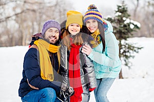 Photo of cheerful family mommy daddy daughter happy positive smile hug cuddle embrace walk park winter snow holiday