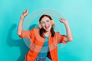 Photo of cheerful funky lady dancing club celebrate birthday nice gift earbuds isolated on cyan color background