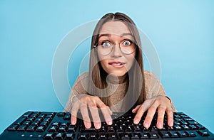 Photo of cheerful funny geek lady typing keyboard look webcam wear specs beige sweater isolated blue color background