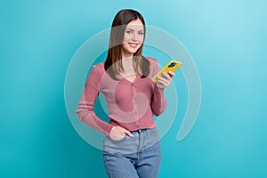 Photo of cheerful girl dressed pink cardigan hold smartphone twitter facebook whatsapp instagram isolated on blue color