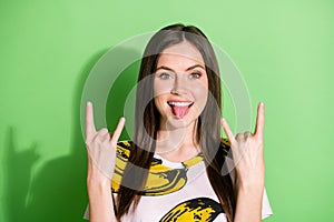 Photo of cheerful happy nice young woman make v-sign hello good mood isolated on green color background