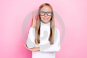 Photo of cheerful intelligent girl toothy smile raise arm know answer isolated on pink color background