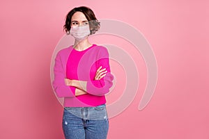 Photo of cheerful lady self-confident person arms crossed good mood look side empty space interested wear medical mask