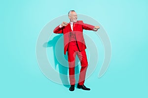 Photo of cheerful man pensioner dressed red three piece tux dancing smiling  teal color background