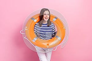 Photo of cheerful nice girl toothy smile hold inflatable circle ring isolated on pink color background