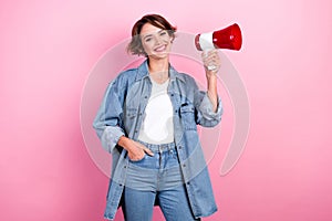 Photo of cheerful optimistic attractive hipster young lady hold megaphone put hand pocket denim shirt newsmaker isolated photo