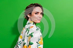 Photo of cheerful positive girl dressed print shirt smiling empty space isolated green color background