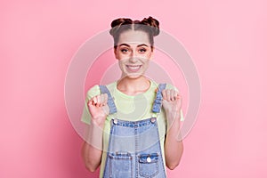 Photo of cheerful positive girl toothy smile wear jeans overall green t-shirt isolated on pink background