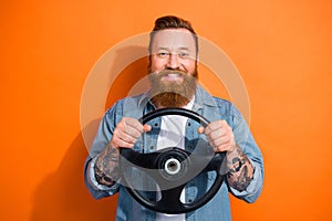 Photo of cheerful positive guy dressed denim jacket rising driving car fast isolated orange color background