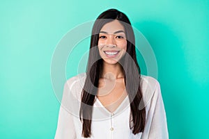 Photo of cheerful positive pretty young vietnamese girl toothy smile isolated on vibrant emerald color background