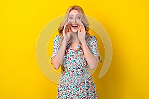 Photo of cheerful pretty gorgeous lady wear trendy sarafan two hands touch face share news isolated on yellow color