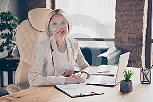 Photo of cheerful professional entrepreneur listening to employee trying to get job at her corporation