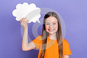 Photo of cheerful schoolgirl holding paper bubble cloud creative idea dreams chatterbox speech  over violet