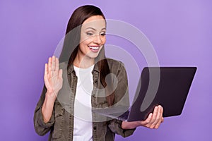 Photo of cheerful smiling beautiful businesswoman have online training say hello isolated on purple color background